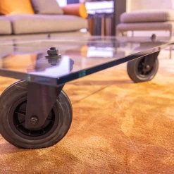 FontanaArte Couchtische|Couchtisch Tavola con Ruota Grande, Design Gea Aulenti 1980, geschliffenes Glas 15 mm, Gestell Rollen schwarz